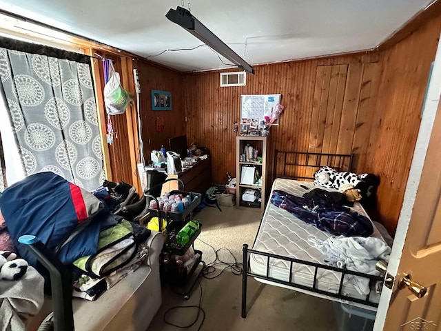 bedroom featuring carpet flooring and wooden walls