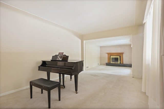 miscellaneous room featuring light carpet and a brick fireplace