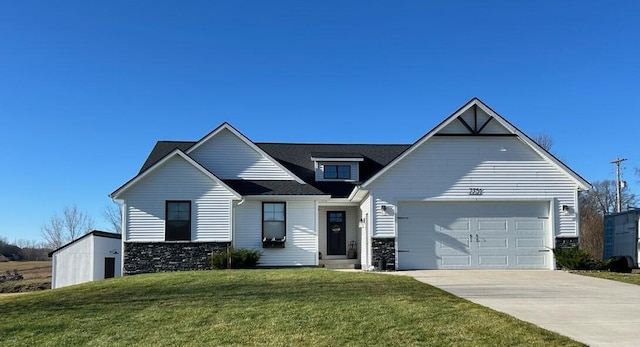 view of front of home with a garage and a front lawn