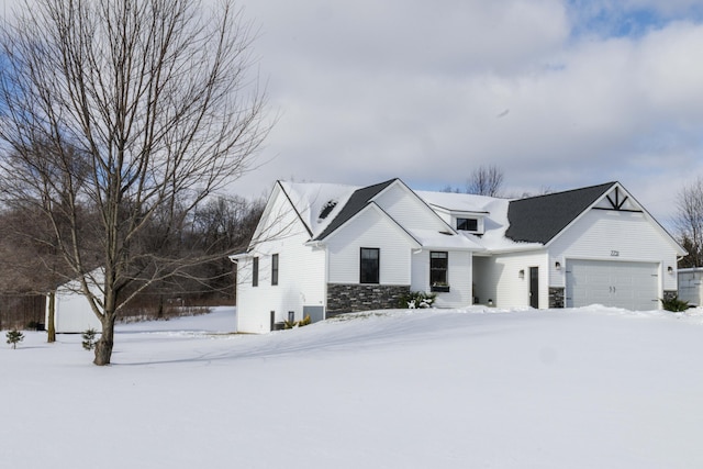 modern inspired farmhouse with a garage