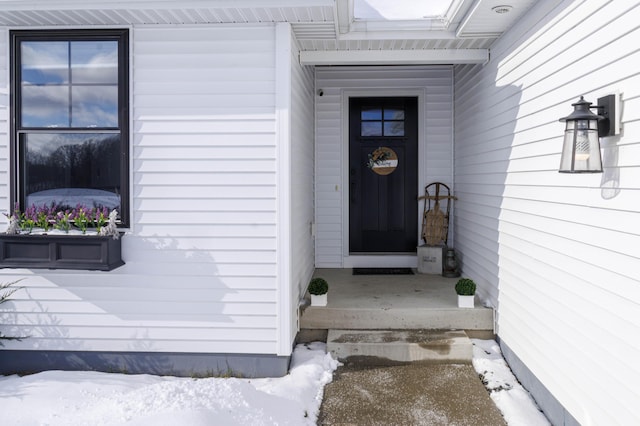 view of snow covered property entrance