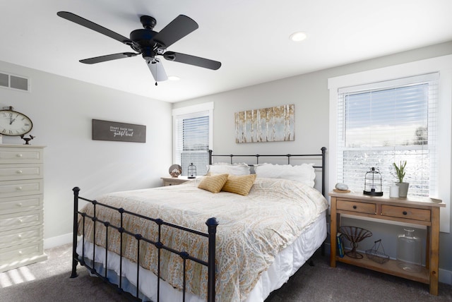 bedroom with ceiling fan and dark carpet