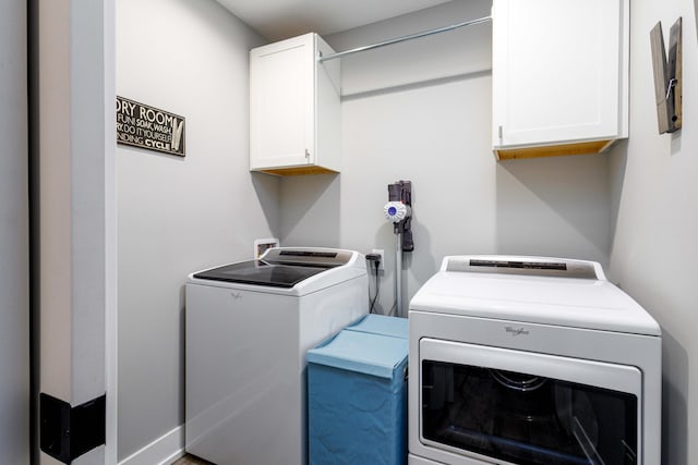 laundry area featuring cabinets and washing machine and clothes dryer