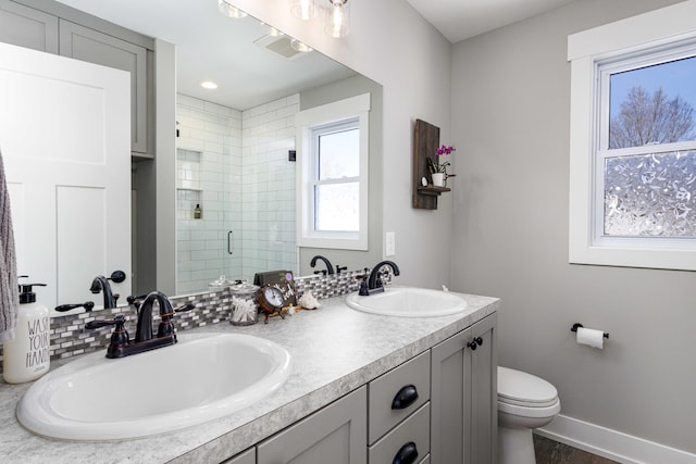 bathroom featuring a shower with door, vanity, hardwood / wood-style flooring, and toilet