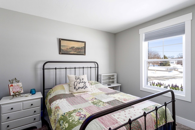 carpeted bedroom with multiple windows