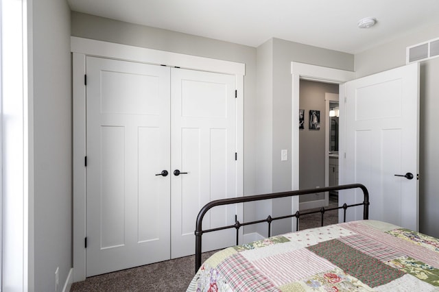 bedroom featuring dark carpet and a closet