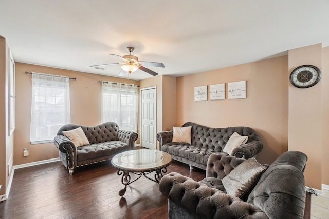 living area featuring ceiling fan, baseboards, and dark wood-style flooring