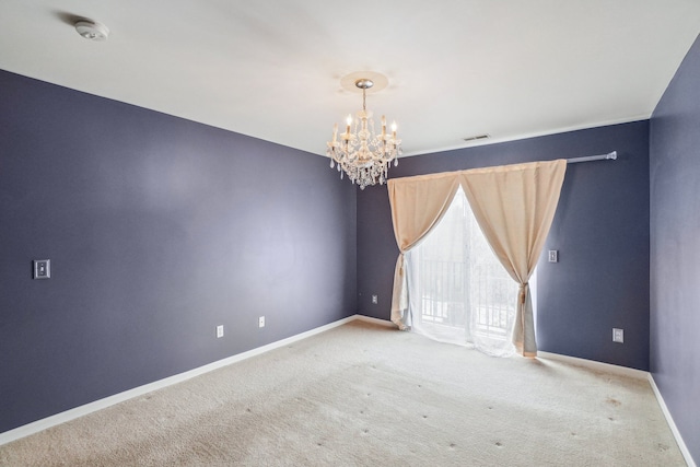 empty room featuring light carpet, an inviting chandelier, visible vents, and baseboards