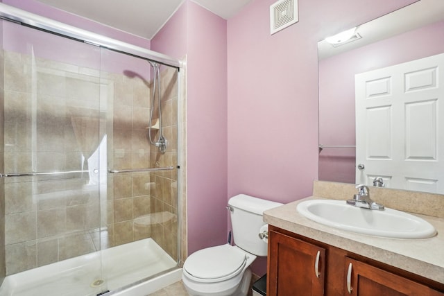 full bathroom with a stall shower, visible vents, vanity, and toilet