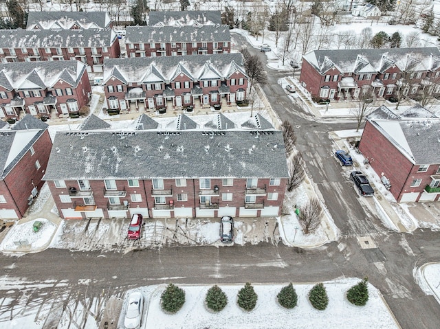 snowy aerial view with a residential view