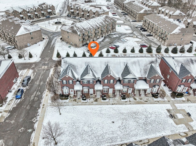 snowy aerial view with a residential view