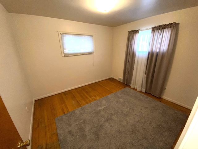 spare room with hardwood / wood-style floors