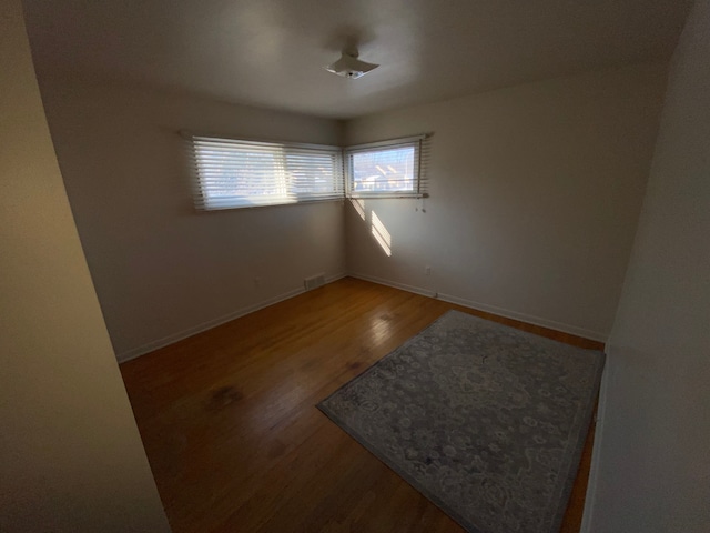 empty room with hardwood / wood-style flooring