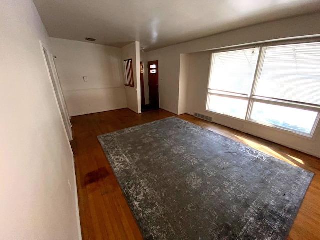 unfurnished room featuring dark wood-type flooring