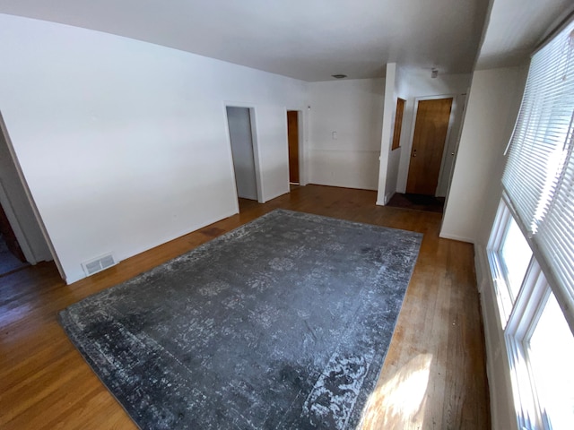 unfurnished room with dark hardwood / wood-style flooring