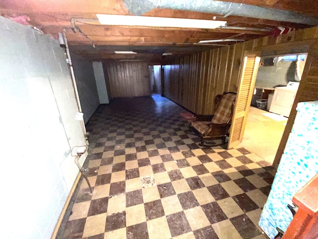 basement with washer / dryer and wood walls