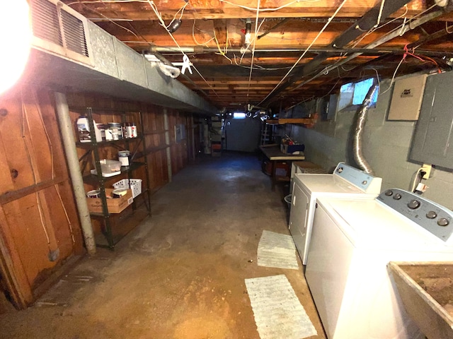 basement with electric panel, separate washer and dryer, and sink