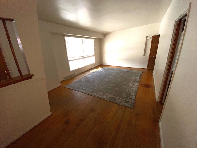 unfurnished room featuring dark hardwood / wood-style floors