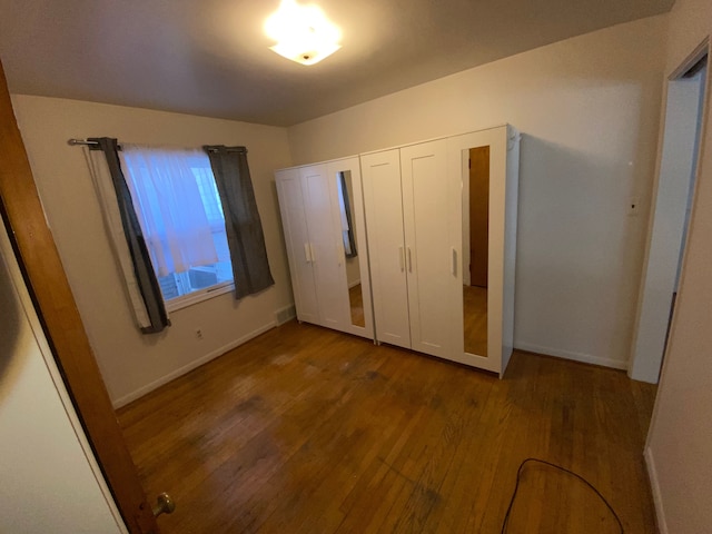 unfurnished bedroom featuring wood-type flooring