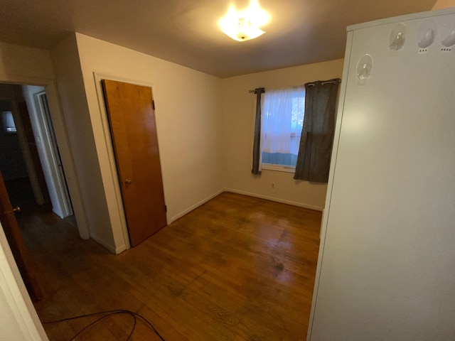 unfurnished room featuring dark wood-type flooring