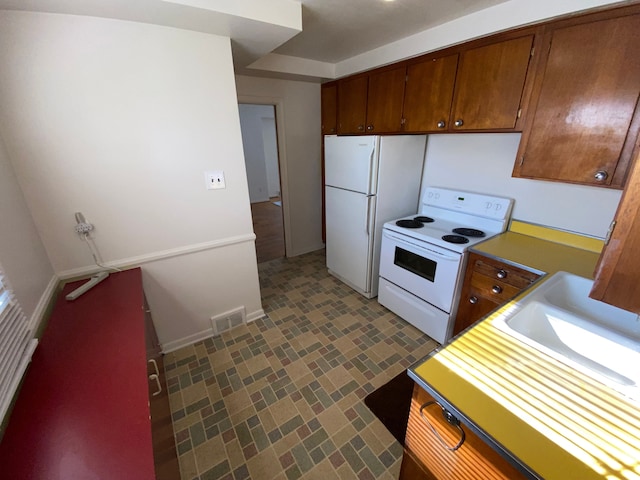 kitchen with sink and white appliances