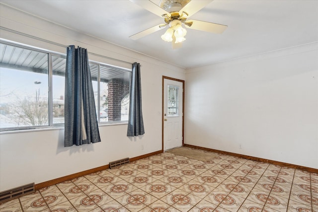 spare room with crown molding and ceiling fan