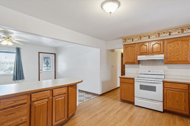 kitchen with light hardwood / wood-style flooring, ceiling fan, white electric range oven, tasteful backsplash, and a textured ceiling