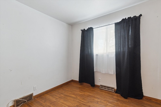 spare room featuring hardwood / wood-style flooring