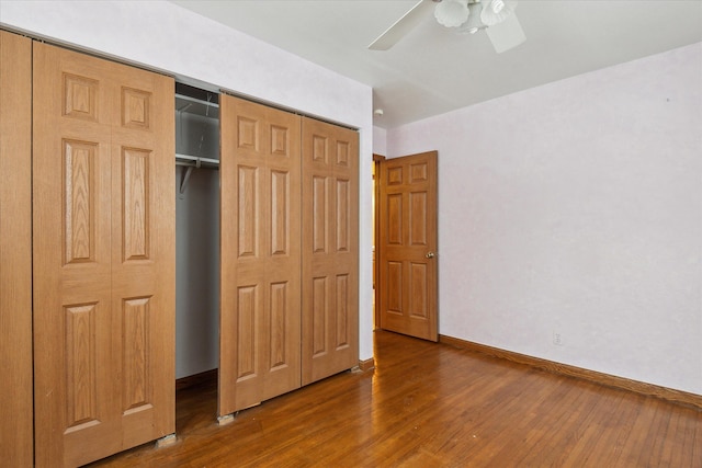 unfurnished bedroom with dark wood-type flooring and ceiling fan