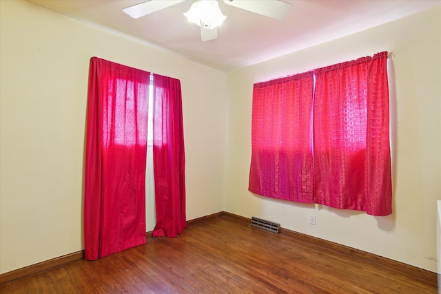 spare room with ceiling fan and dark hardwood / wood-style flooring