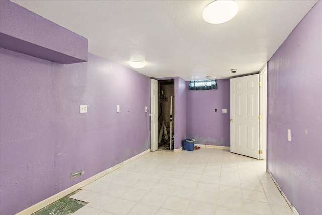 basement featuring a textured ceiling