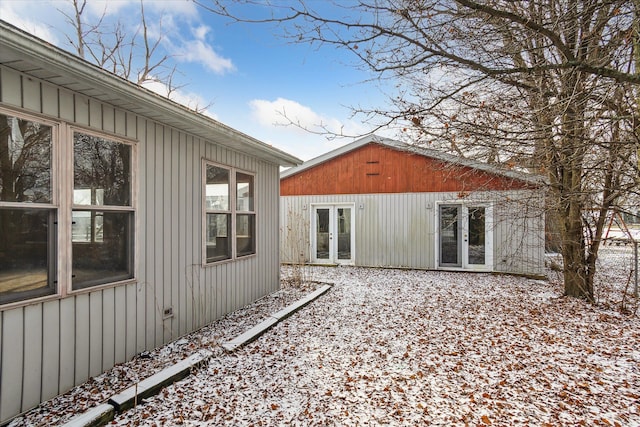 view of snowy exterior with french doors