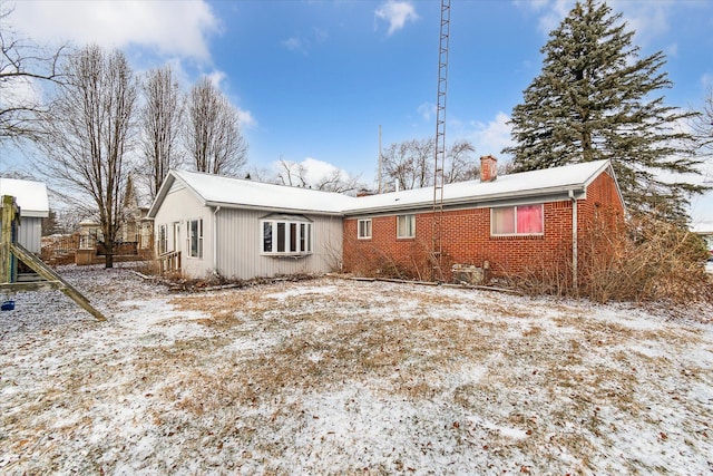 view of snow covered rear of property