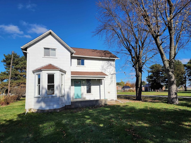 rear view of property with a lawn