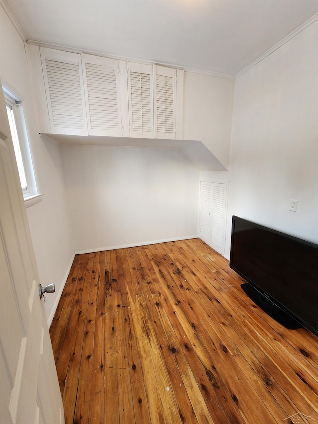 interior space featuring crown molding and hardwood / wood-style floors