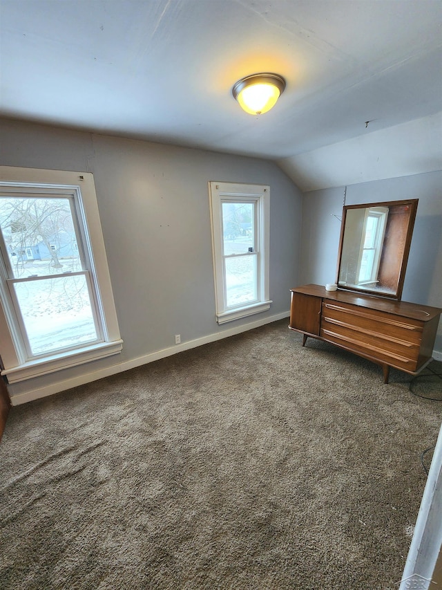 bonus room with carpet flooring and vaulted ceiling