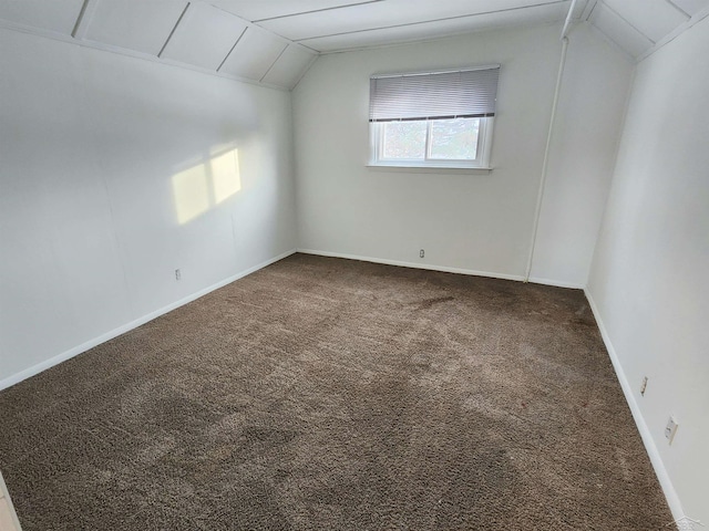 additional living space featuring lofted ceiling and carpet