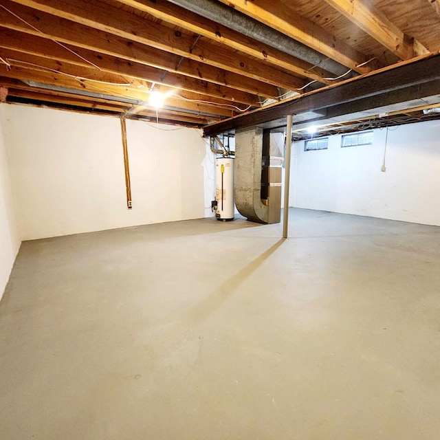 basement featuring heating unit and water heater