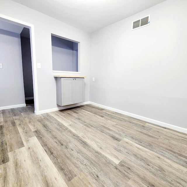 spare room with light hardwood / wood-style flooring