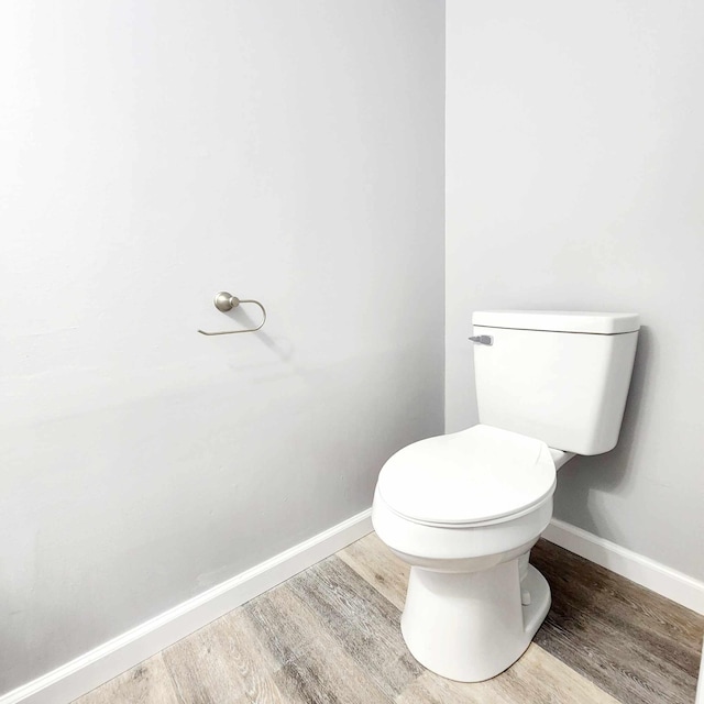 bathroom featuring hardwood / wood-style floors and toilet