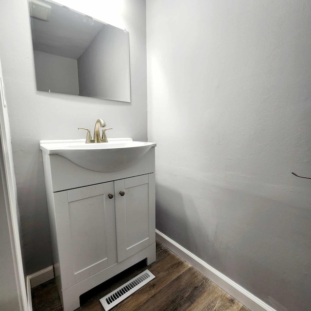 bathroom featuring hardwood / wood-style flooring and vanity