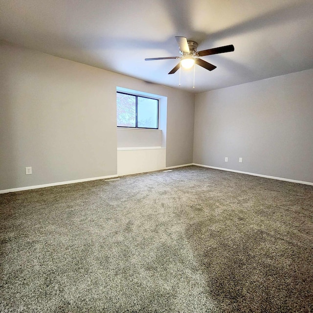 empty room with carpet floors and ceiling fan