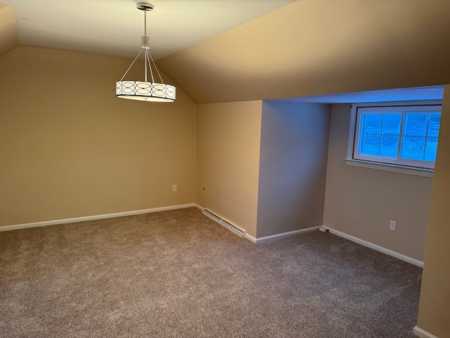 interior space with a baseboard radiator, carpet flooring, and vaulted ceiling