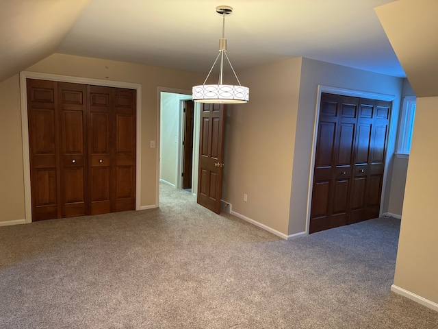 interior space with lofted ceiling and carpet floors