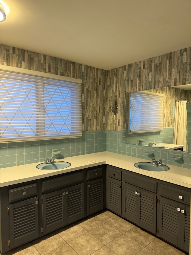 bathroom featuring decorative backsplash, tile patterned floors, and vanity