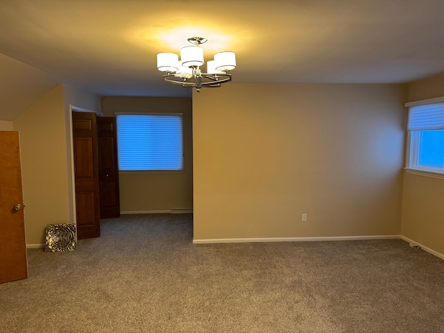 empty room with vaulted ceiling, carpet, and a notable chandelier