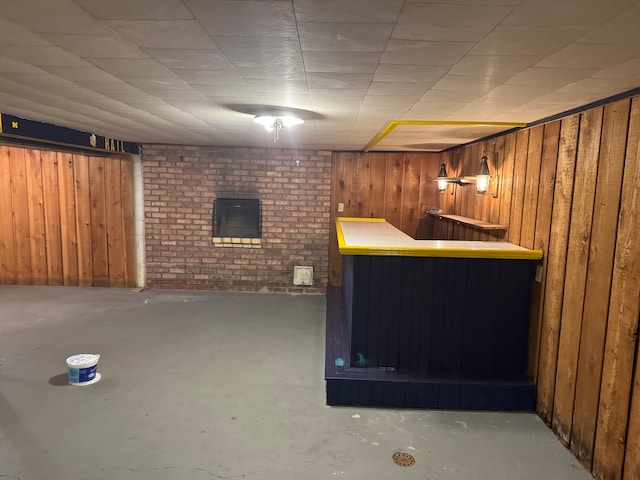 bar with concrete flooring and wood walls