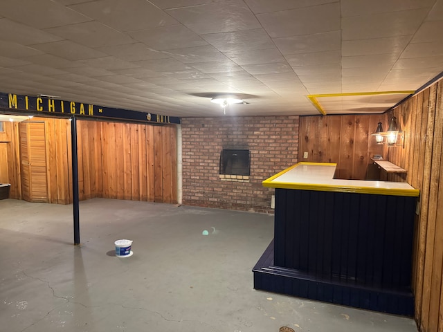 basement with bar and wood walls