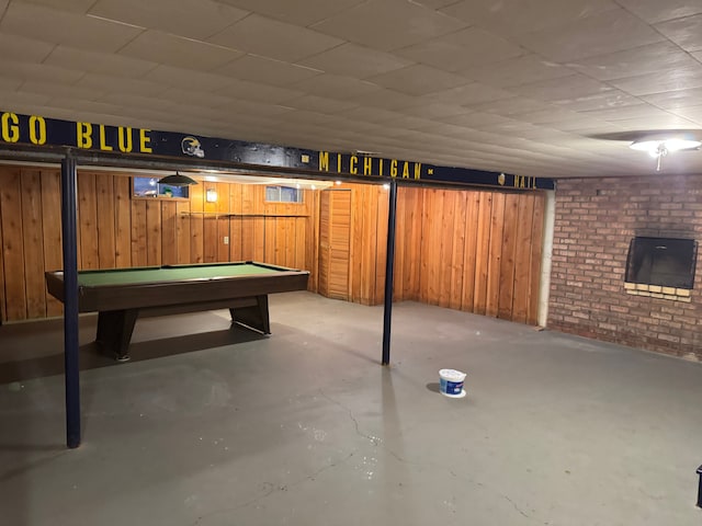 basement with pool table and wood walls