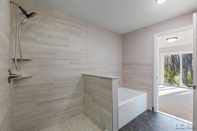 bathroom featuring separate shower and tub